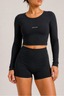 Close-up front view of midnight navy long-sleeve cropped active top and high-waisted fitted active shorts