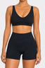 Front view of midnight navy scoop-neck sports bra and high-waisted fitted active shorts