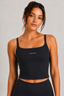 Close-up front view of model wearing midnight navy square-neck cropped active tank with slim straps