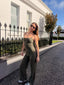 Daily Wide Leg Pants in Field Green, lifestyle photo of model in sunglasses wearing the pants with a matching Field Green cami, standing outdoors