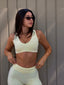 Daily Sports Bra in Butter, lifestyle photo of model in sunglasses wearing the V-neck sports bra with matching Butter bottoms