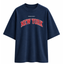 A navy blue oversized short-sleeve t-shirt with 'PRINCE X MOTT' printed in small white letters above 'NEW YORK' in arched red varsity-style lettering with a white outline on the chest, shown against a plain white background.